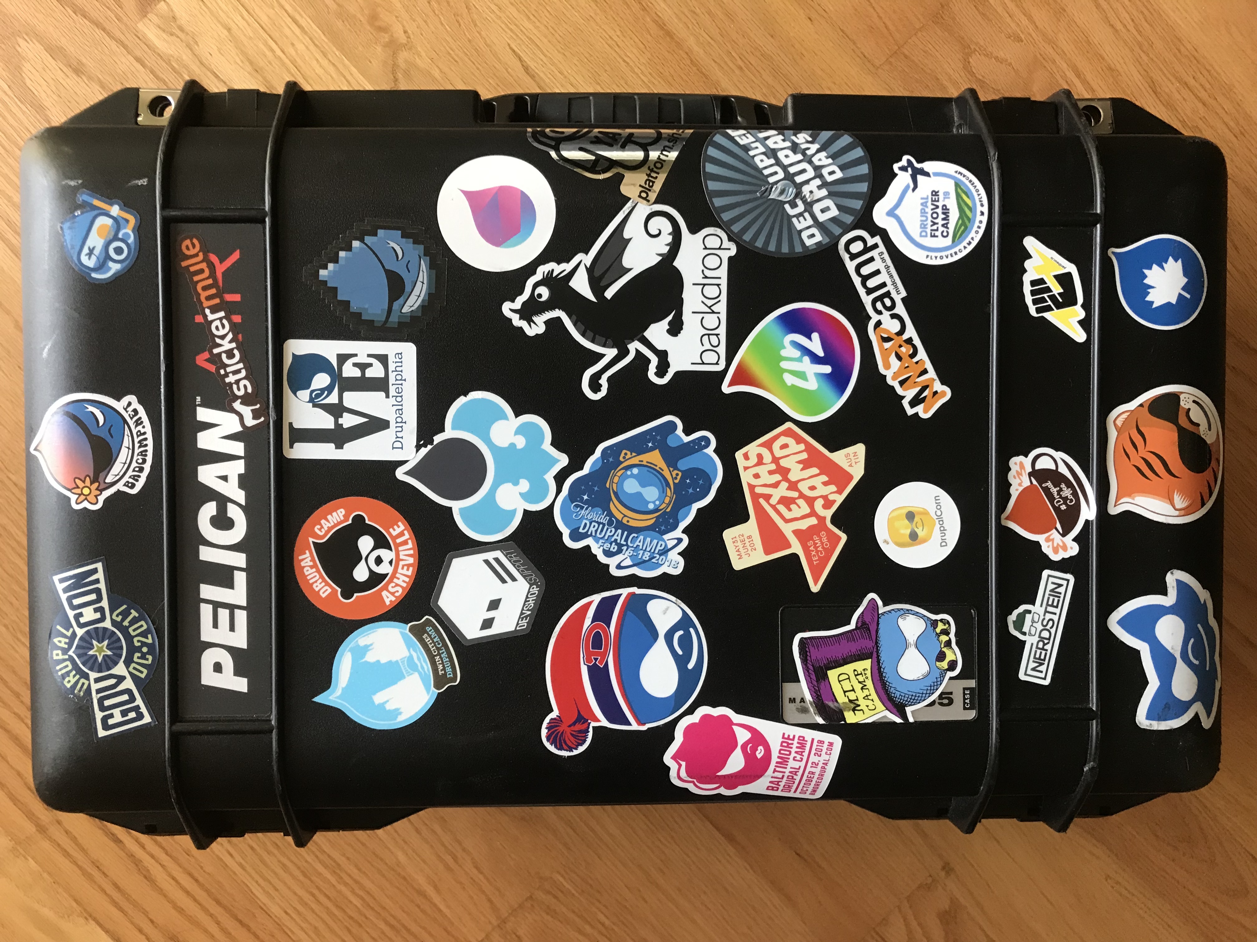 Pelican case covered in Drupal camp stickers
